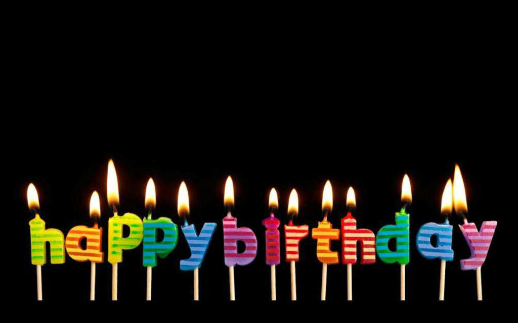 Vibrant Birthday Wallpaper: Colorful Candles on Black Background