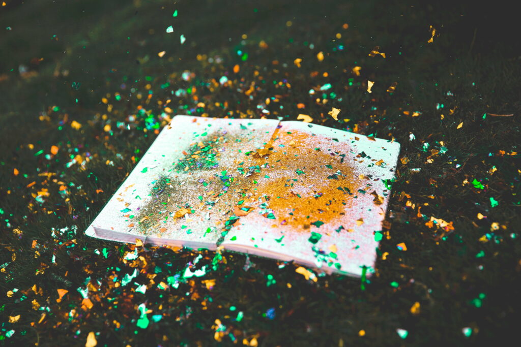 Sparkling Literary Fiesta: A Vibrant HD Wallpaper Featuring Books, Glitter, and Colorful Confetti