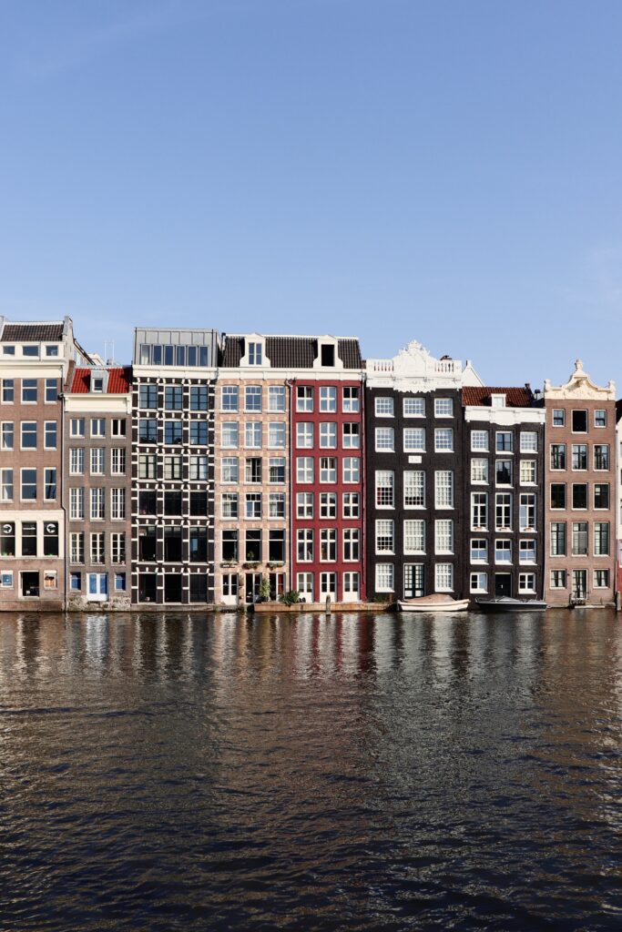 Colorful Facades Reflected in Calm Waterway - Serene Cityscape Wallpaper