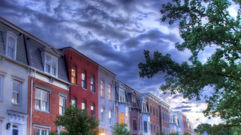 Colorful Building Wallpaper: Dramatic Sky & Lush Green Trees