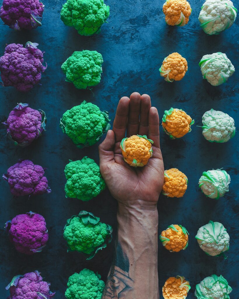 Artistic Colorful Cabbages Wallpaper with Tattooed Hand Accent