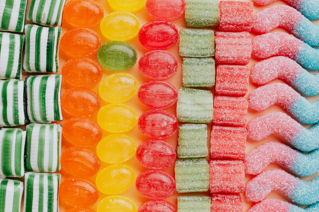 Colorful candy wallpaper with striped green sweets fruit drops sugar chews and gummy sticks background
