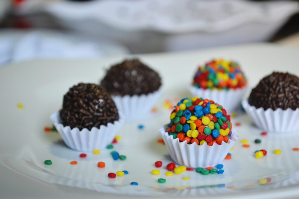 Colorful Candy-Coated Chocolates Wallpaper Background in White Cups