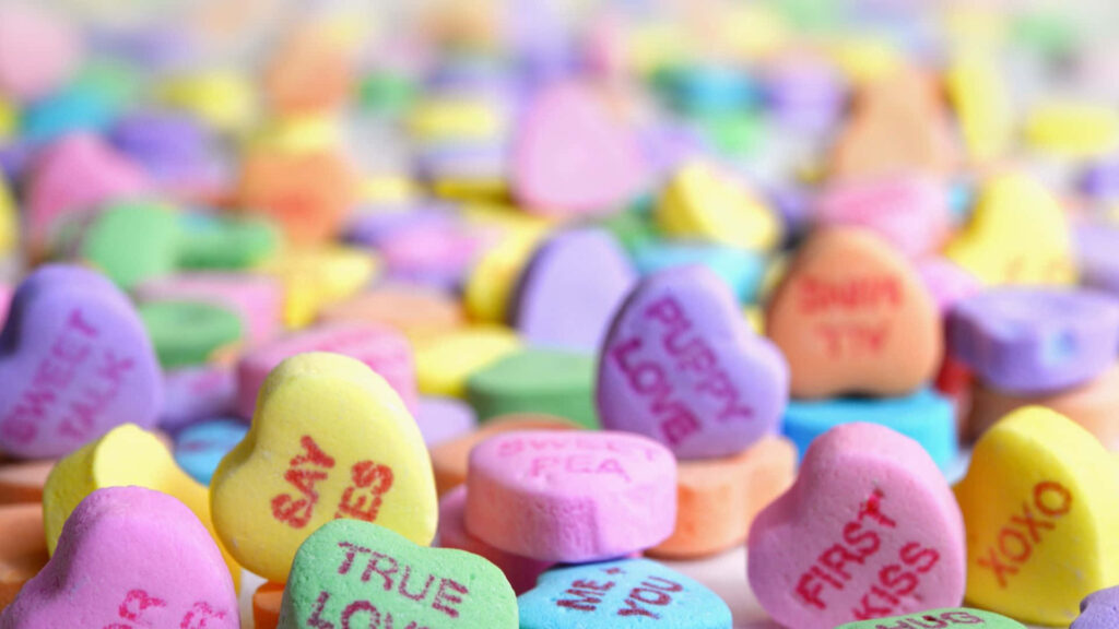 Cheerful Candy Hearts Wallpaper: Festive Valentine Background