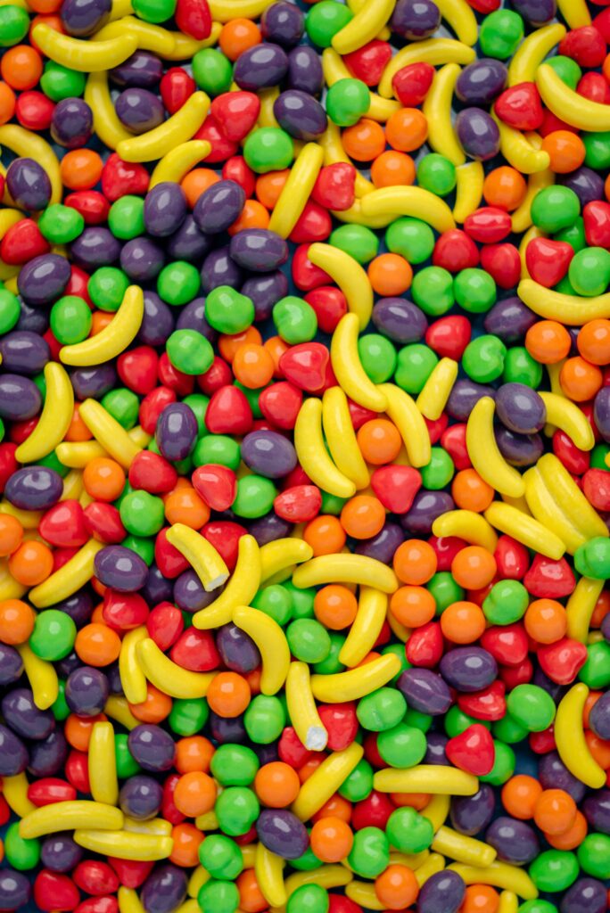 Colorful Candy-Shaped Pill Wallpaper: Playful Banana & Sweet Design