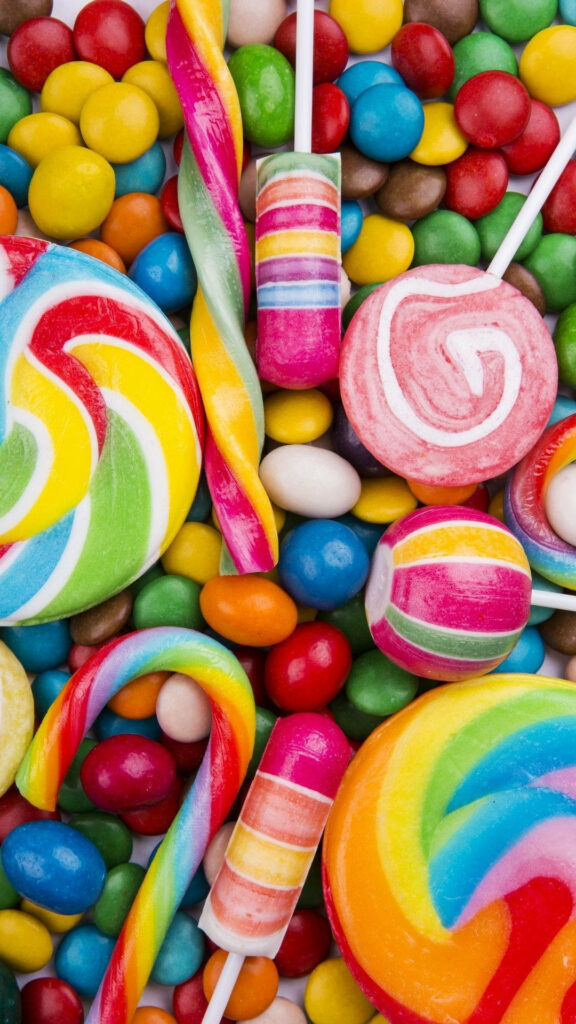 Vibrant wallpaper with colorful assorted candies lollipops candy canes and round sweets