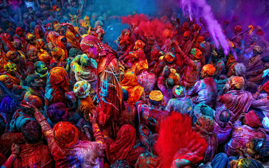 Colorful Carnage: A Stunning Aerial View of the Massive Crowd Celebrating Happy Holi Wallpaper