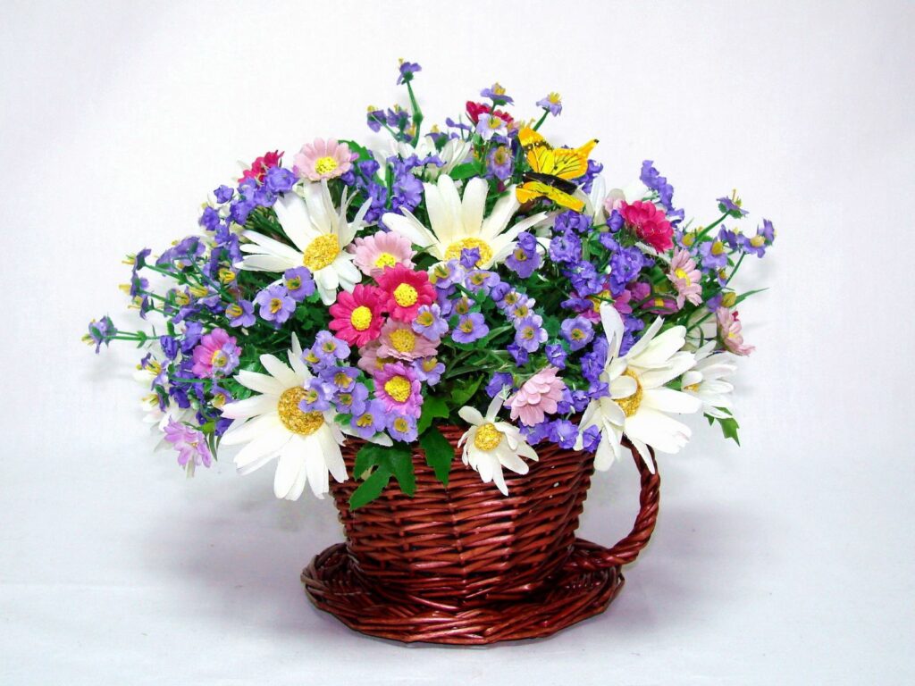 Colorful Chamomile and Blossoms in Woven Basket - Nature's Charm Wallpaper