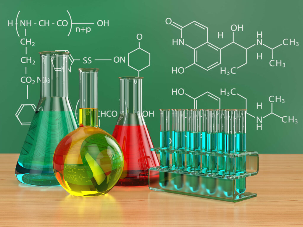 Chemistry wallpaper with vibrant lab glassware and formulas on green chalkboard educational background