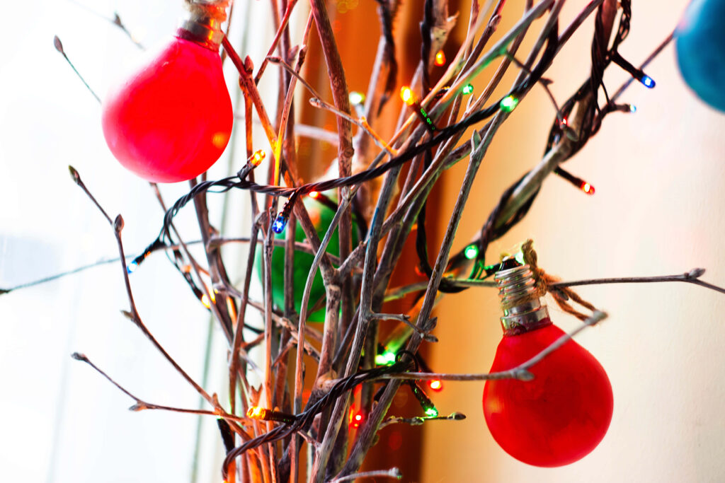 Cheerful Christmas Lights on Bare Branches Festive Wallpaper Background
