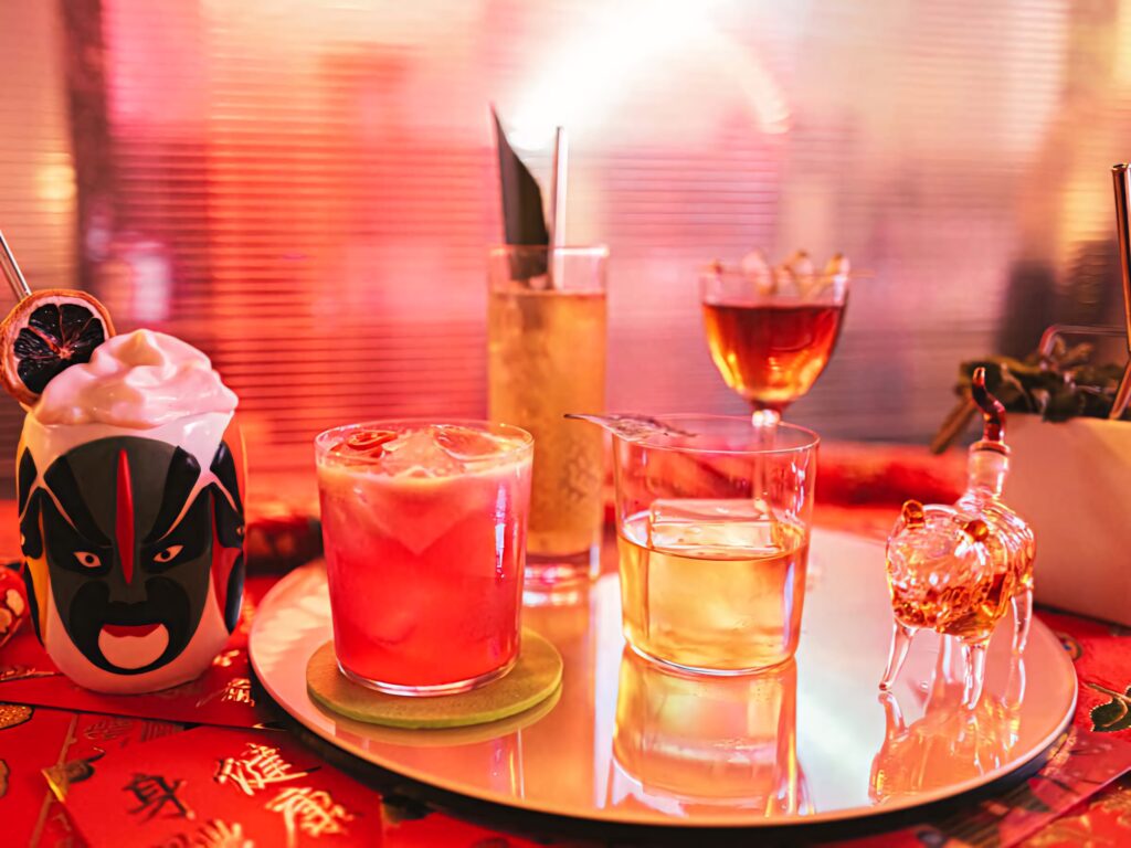 Vibrant colorful cocktail wallpaper with unique glassware garnishes ceramic mug and crystal tiger