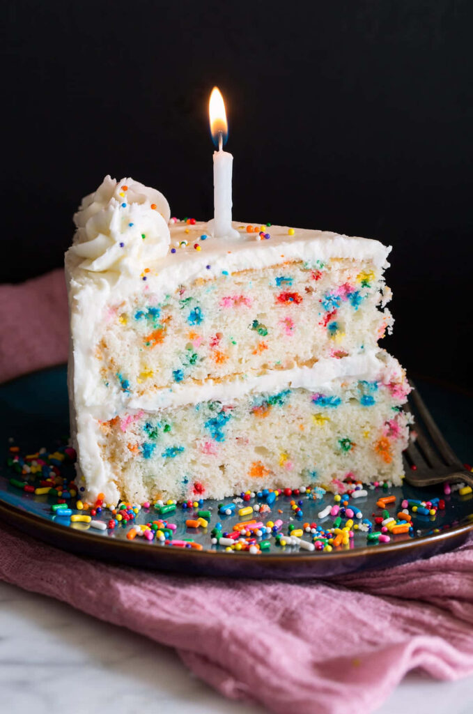 Colorful Confetti Cake with Candle on Dark Background - Festive Wallpaper