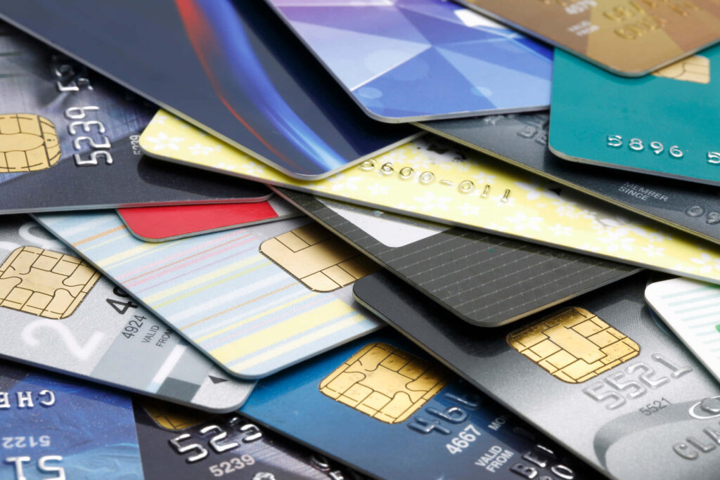 Colorful stacked credit cards with metallic chips and glossy finishes symbolize modern finance Wallpaper