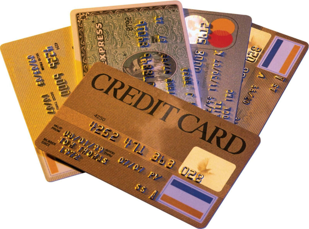 Stacked colorful credit cards with embossed numbers showcasing finance and consumerism themes Wallpaper