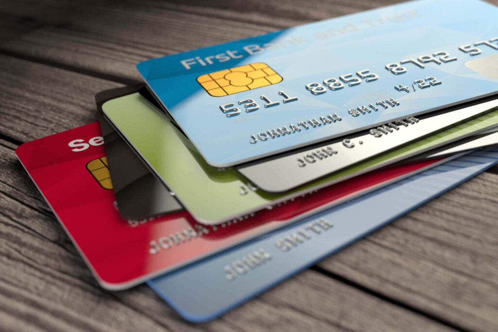 Colorful credit cards fanned on rustic wood highlighting finance modern lifestyle and banking Wallpaper