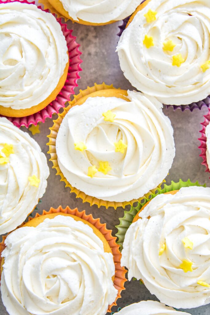 Colorful Cupcake Wallpaper: Creamy Frosting & Star Decorations