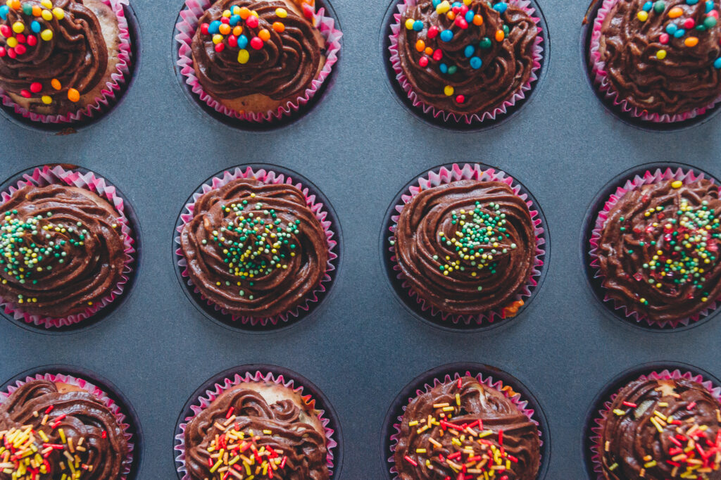 Colorful Chocolate Cupcake Wallpaper: Dessert Artistry Background