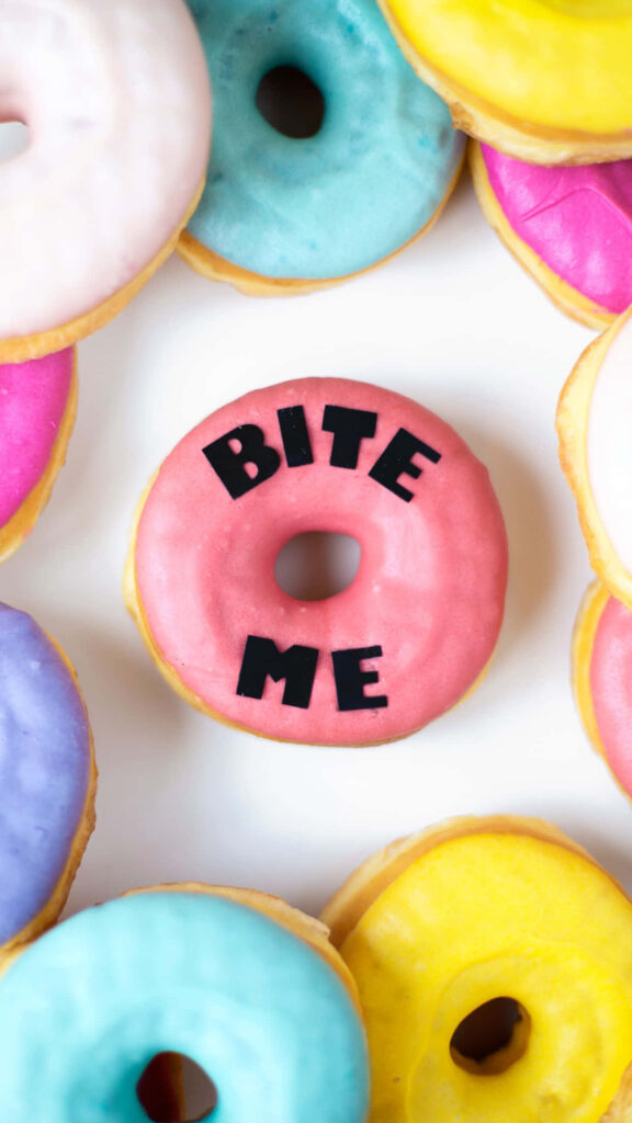 Vibrant Donut Wallpaper: Colorful Design with 'BITE ME' Text