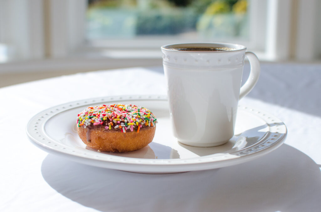 Colorful Sprinkled Donut & Tea Wallpaper in Bright Natural Light