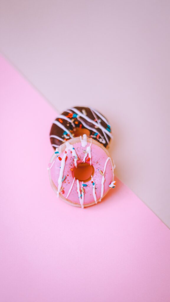 Colorful Donut Wallpaper: Pink Icing & Chocolate Glaze Delight