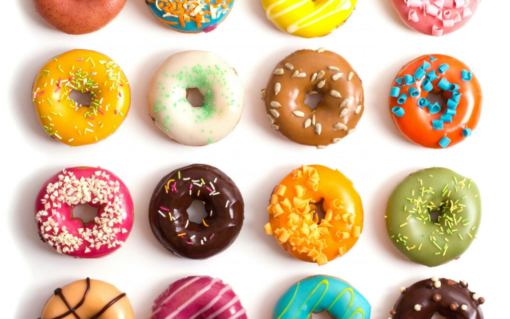 Colorful Doughnut Wallpaper with Tasty Toppings and Sprinkles