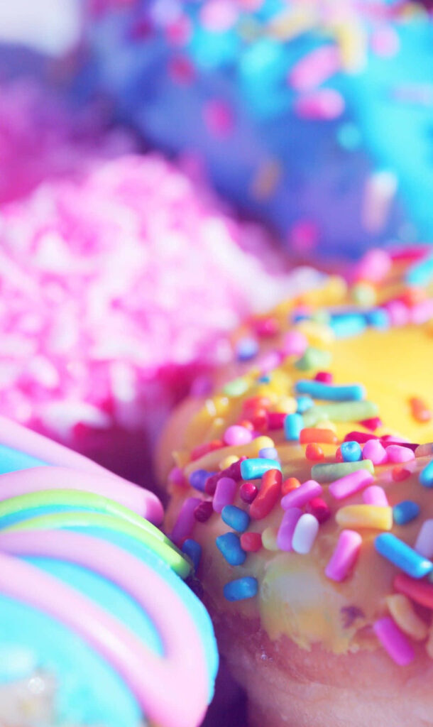 Bright Doughnut Wallpaper: Colorful Icing & Sprinkles Delight