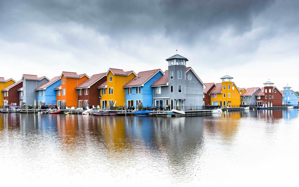Charming Dutch Houses Reflecting on Water - Moody Sky Wallpaper