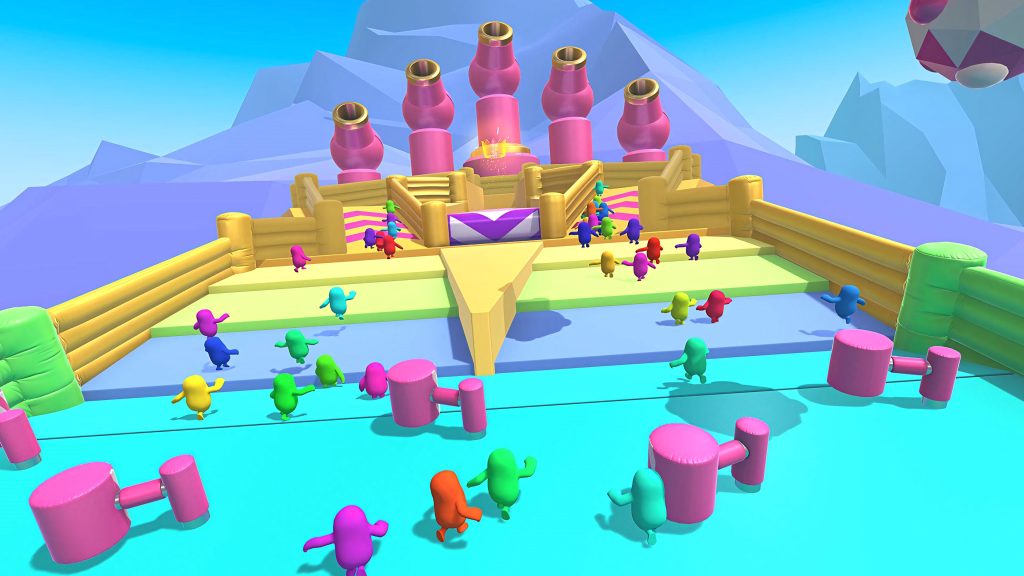 Colorful Fall Guys characters race through obstacle course with hammers and icy mountains background Wallpaper