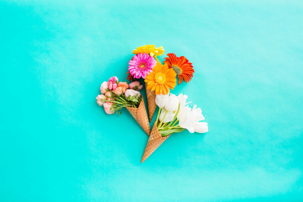 Playful Floral Ice Cream Cone Wallpaper on Bright Turquoise Background