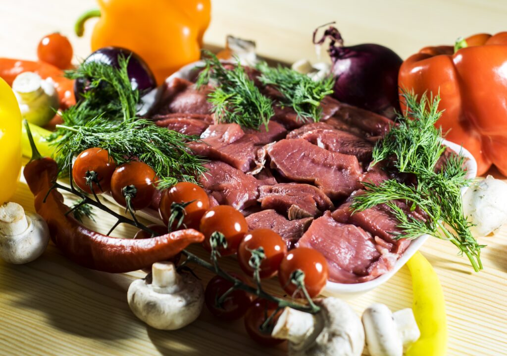 “Vibrant Goat Meat & Veggies Wallpaper Background for Cooking Enthusiasts”