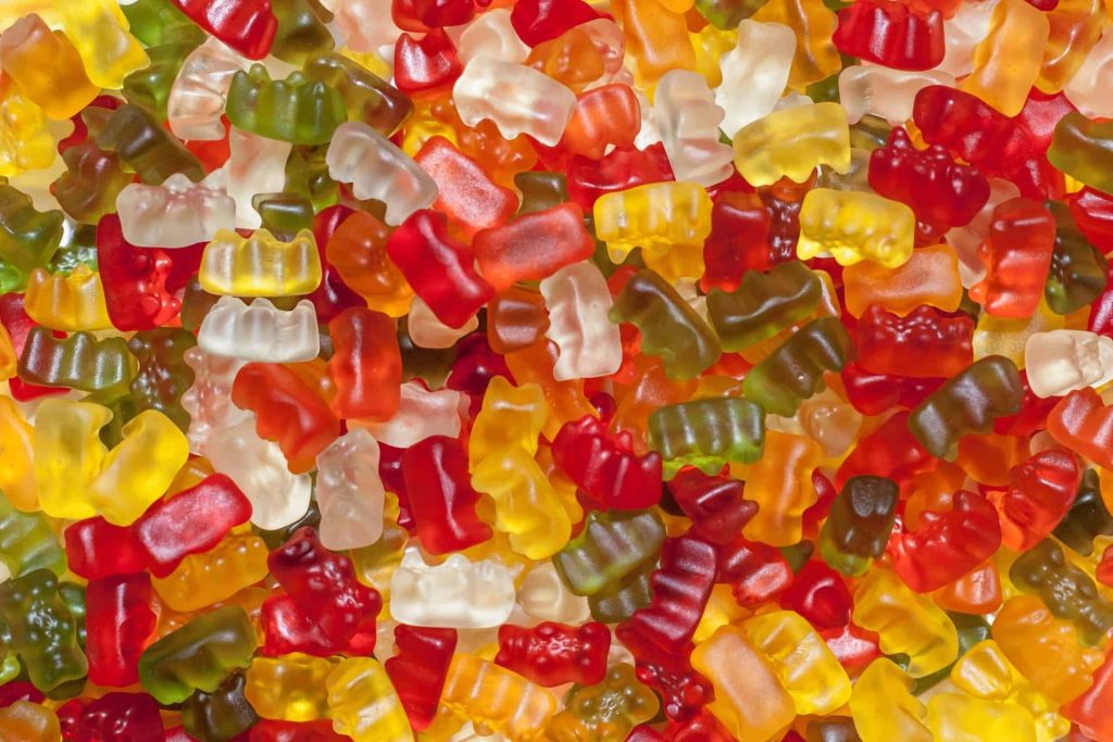 Colorful translucent gummy bears close up vibrant candy texture macro wallpaper background
