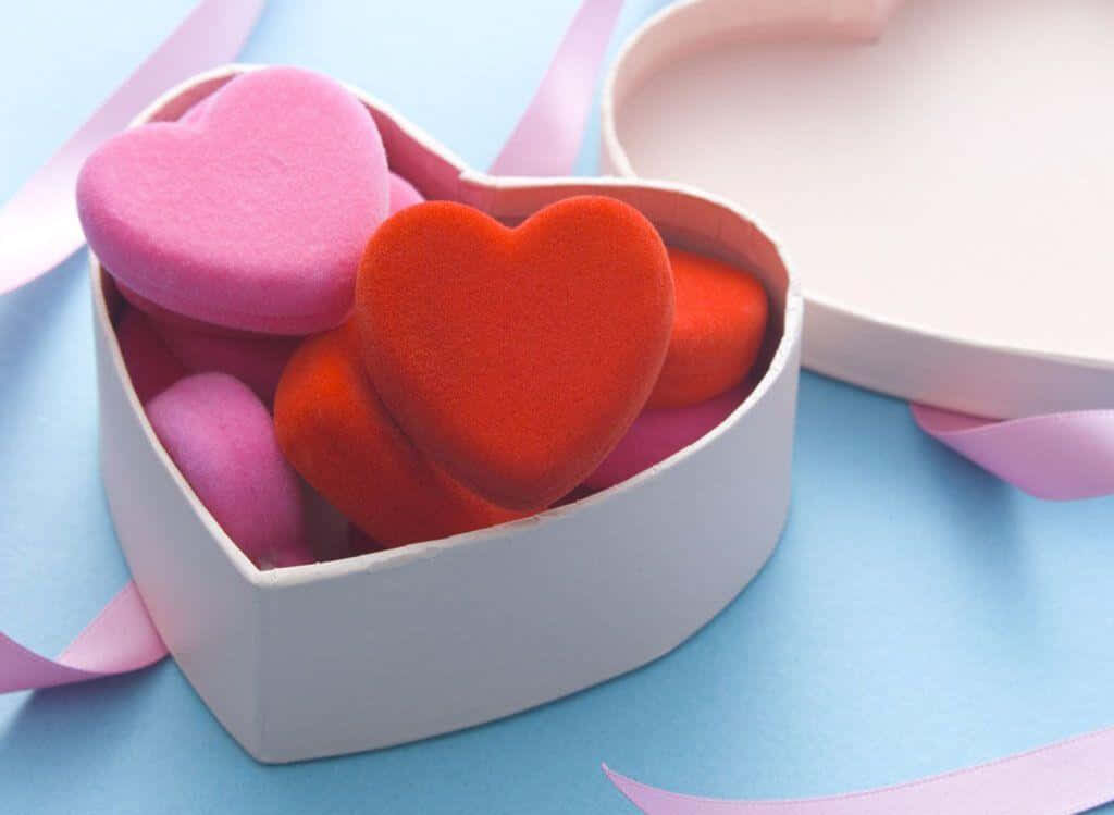 Colorful Heart-Shaped Box Wallpaper: Love & Joy on Pastel Blue