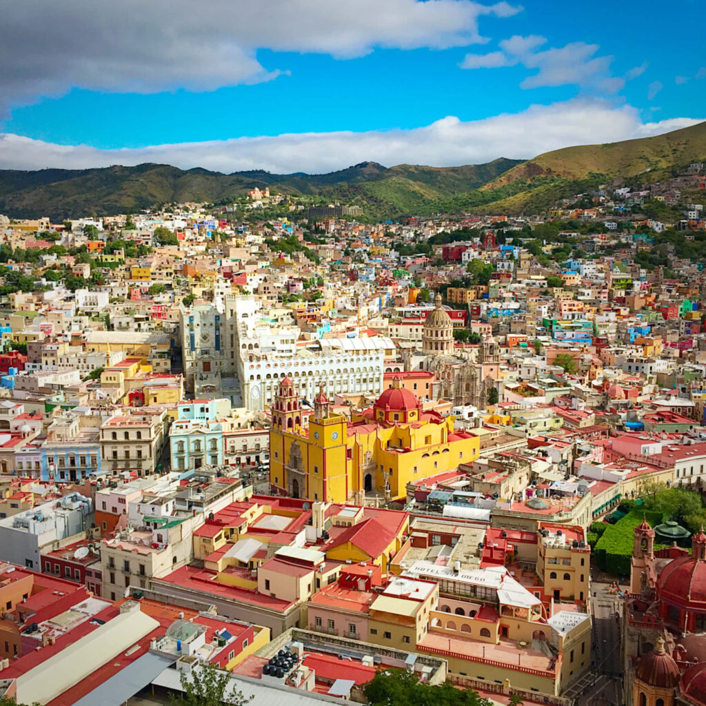 Vibrant Historic City Wallpaper: Colonial Architecture & Blue Sky