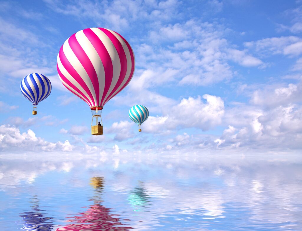 Colorful Hot Air Balloons in Serene Sky & Calm Sea Wallpaper