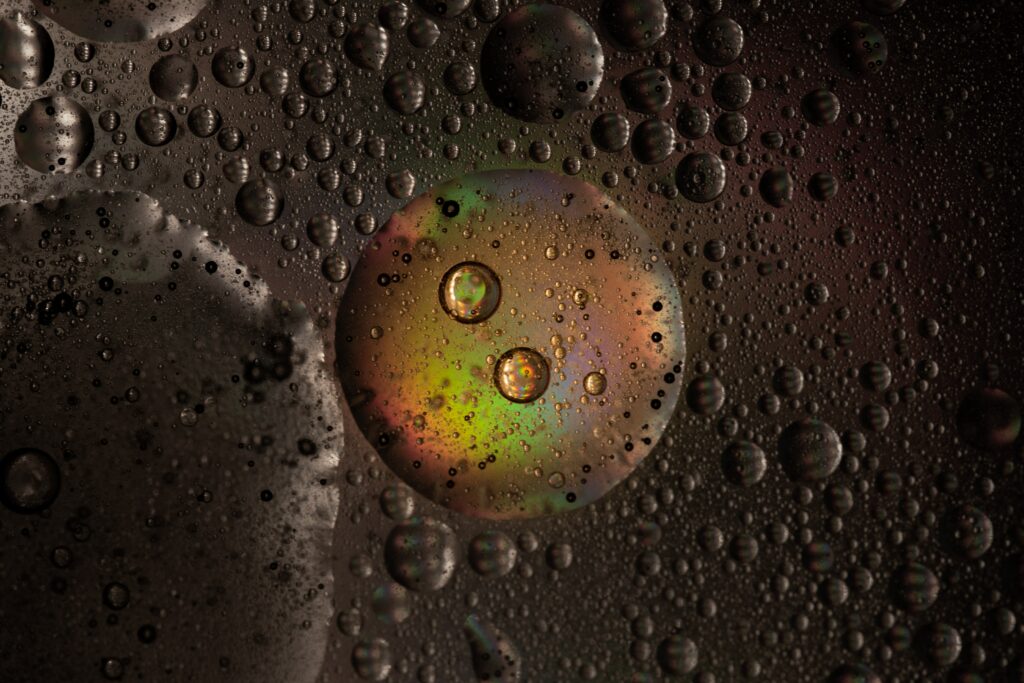 Vibrant Water Droplets & Iridescent Bubble Wallpaper on Dark Background