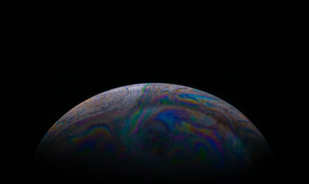Colorful Iridescent Soap Bubble Macro: Striking Dark Wallpaper