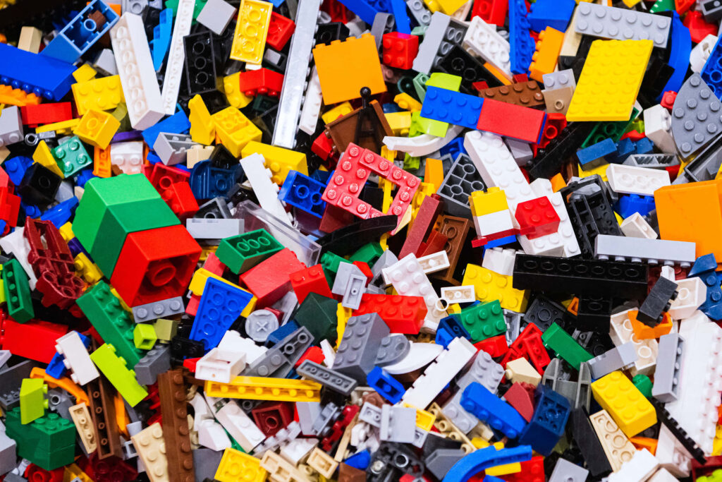 Vibrant colorful assorted Lego bricks in various shapes creating playful creative inspiration background Wallpaper