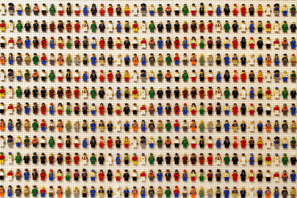 Colorful Lego minifigures in neat rows vibrant diverse characters wallpaper background image
