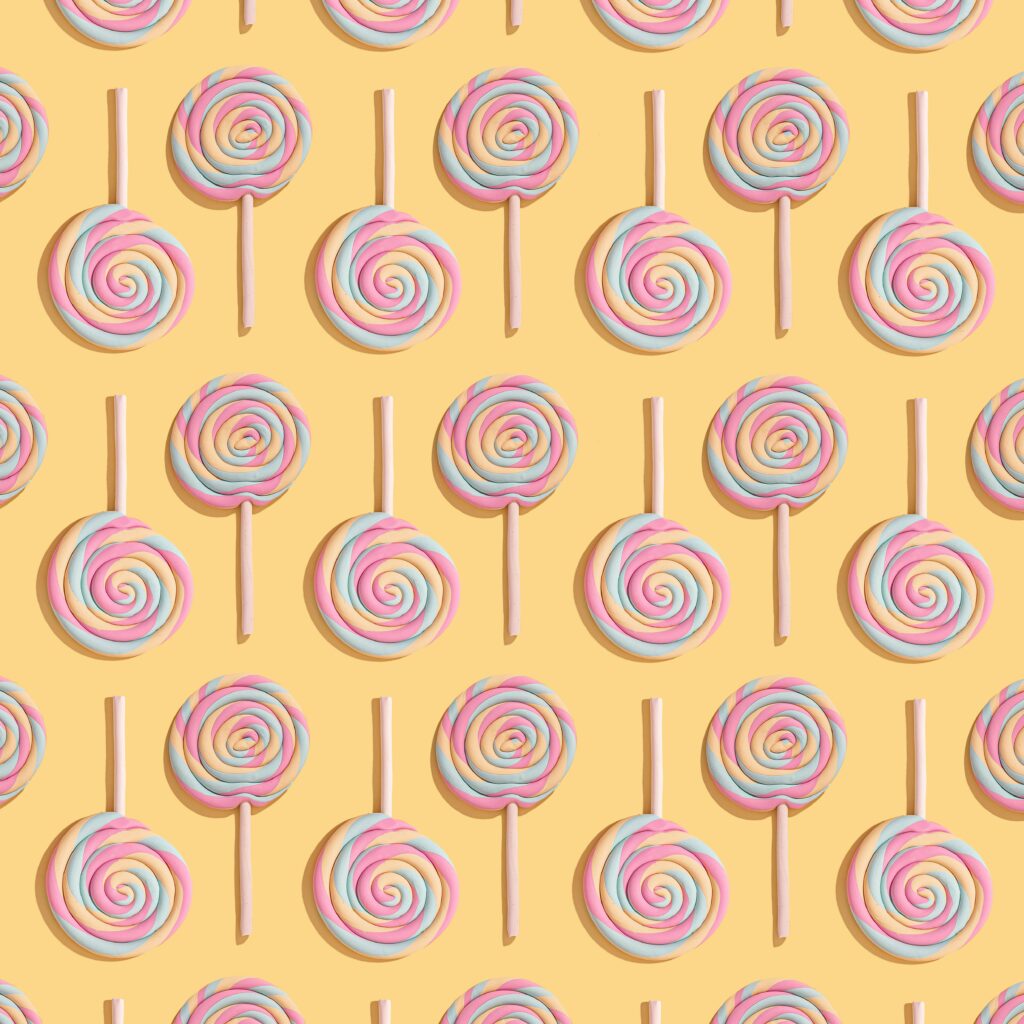 Colorful Lollipop Wallpaper: Fun & Sweet Yellow Background Design