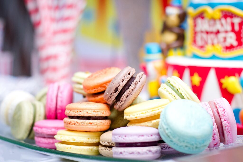 Colorful Macarons Display with Festive Pastries – Wallpaper Background