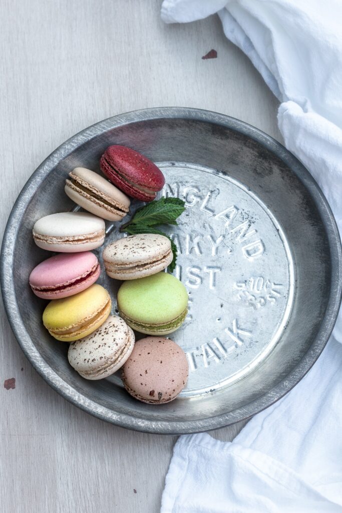 Colorful Macarons & Cookies on Rustic Plate - Wallpaper Background
