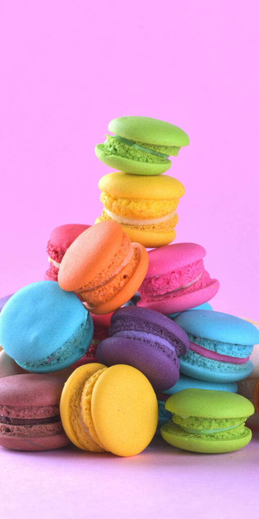Colorful Macarons Wallpaper: Cheerful Pink Background for iPhone