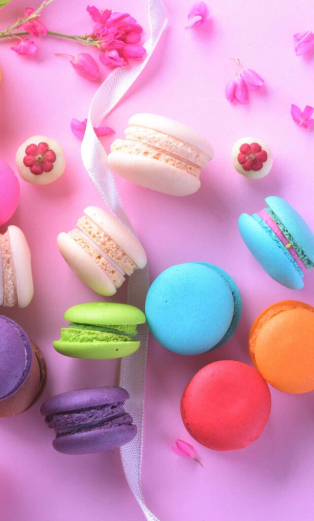 Colorful Macaron iPhone Wallpaper on Pink with Flowers & Ribbon