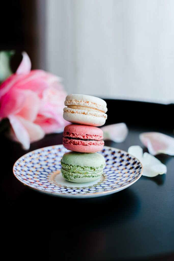 Colorful Macarons on Patterned Plate with Petals - Elegant Wallpaper