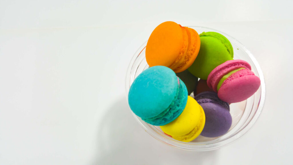Vibrant Colorful Macaroons on White Background - Delightful Wallpaper