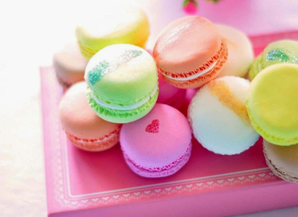 Charming Macaroon Wallpaper: Colorful Sweetness on a Pink Background