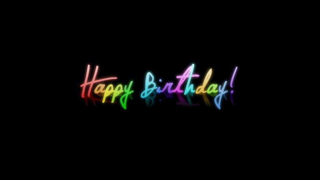 Celebratory Glow: Vibrant Neon Birthday Sign Shines Against Ebony Backdrop Wallpaper