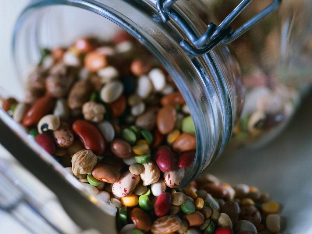 Colorful Nuts & Legumes in Glass Jar - Textured Wallpaper Background