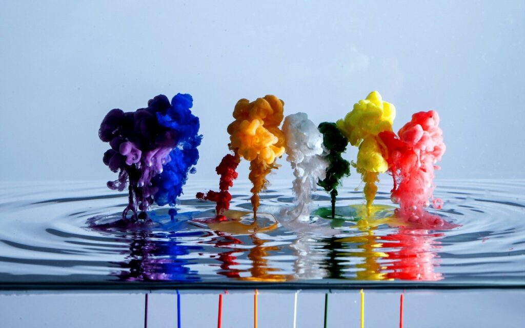 Colorful Paint Plumes in Water: Stunning Abstract Wallpaper