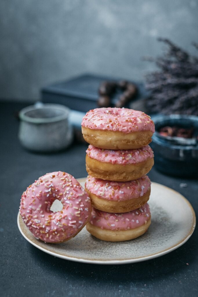 Colorful Pink-Iced Donuts Still Life Wallpaper - Tasty Delight